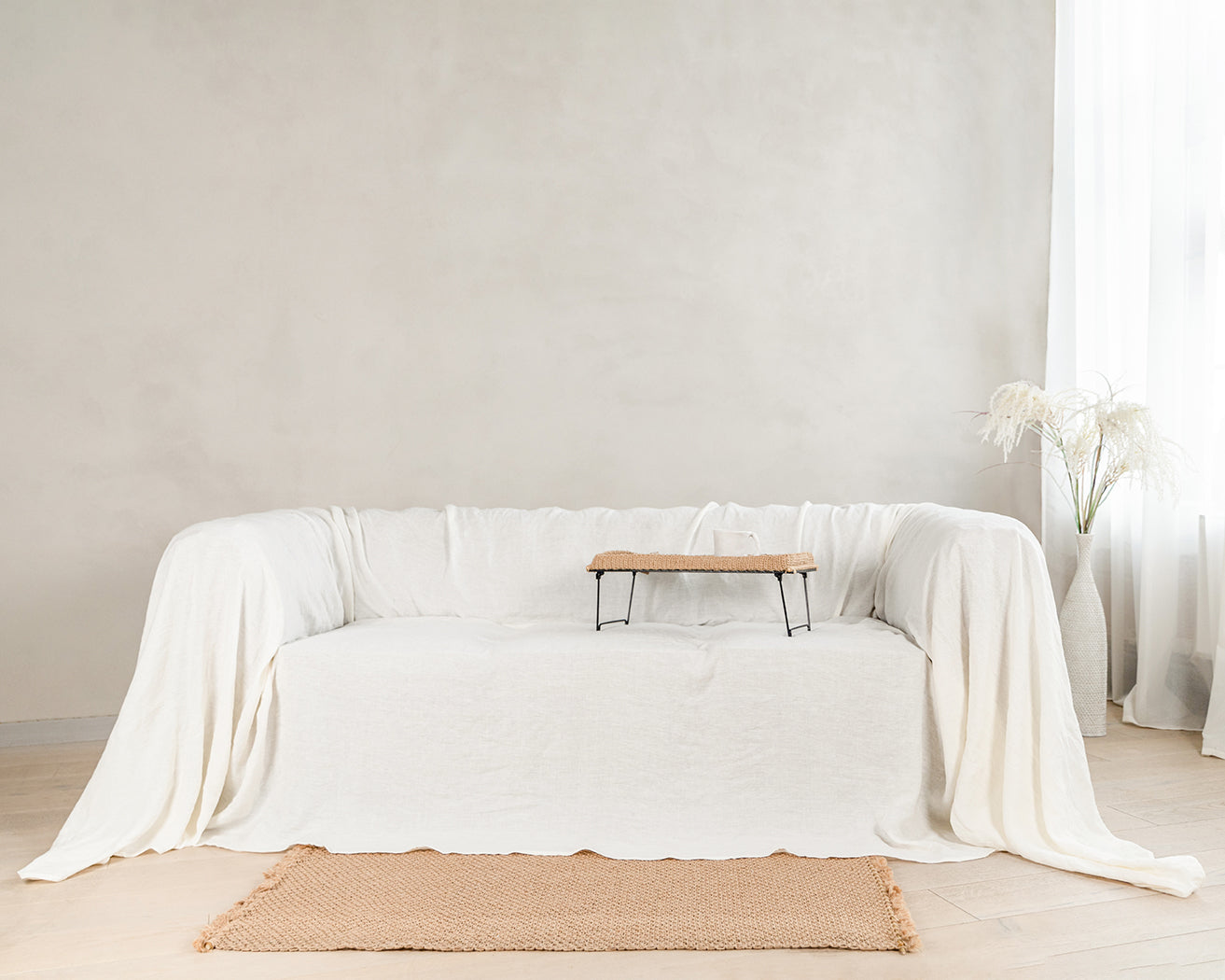 a living room with a white couch and a table