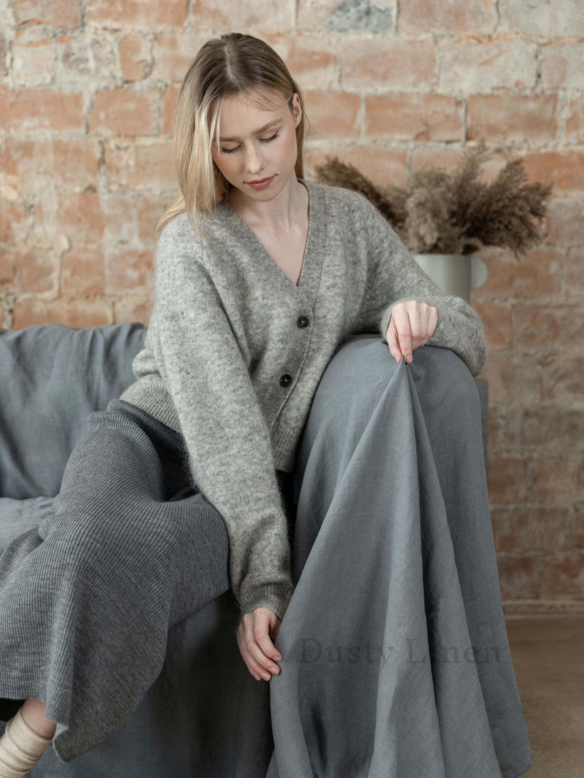 a woman sitting on a couch with her legs crossed