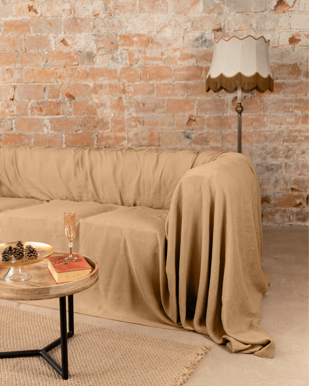 a living room with a couch covered in a blanket