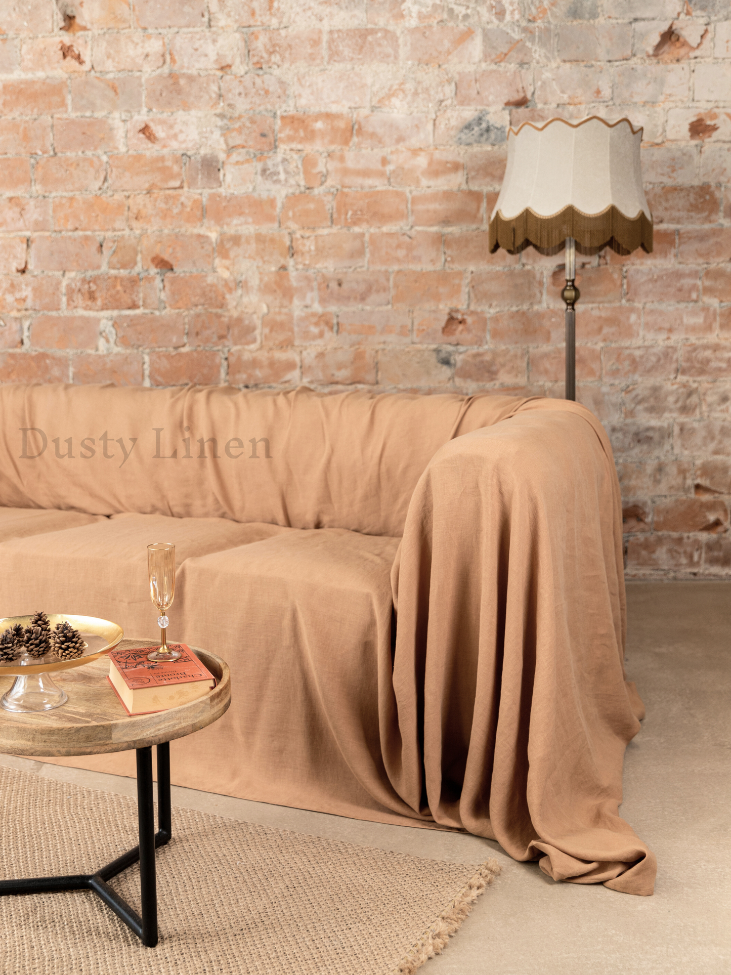 a living room with a couch covered in a blanket