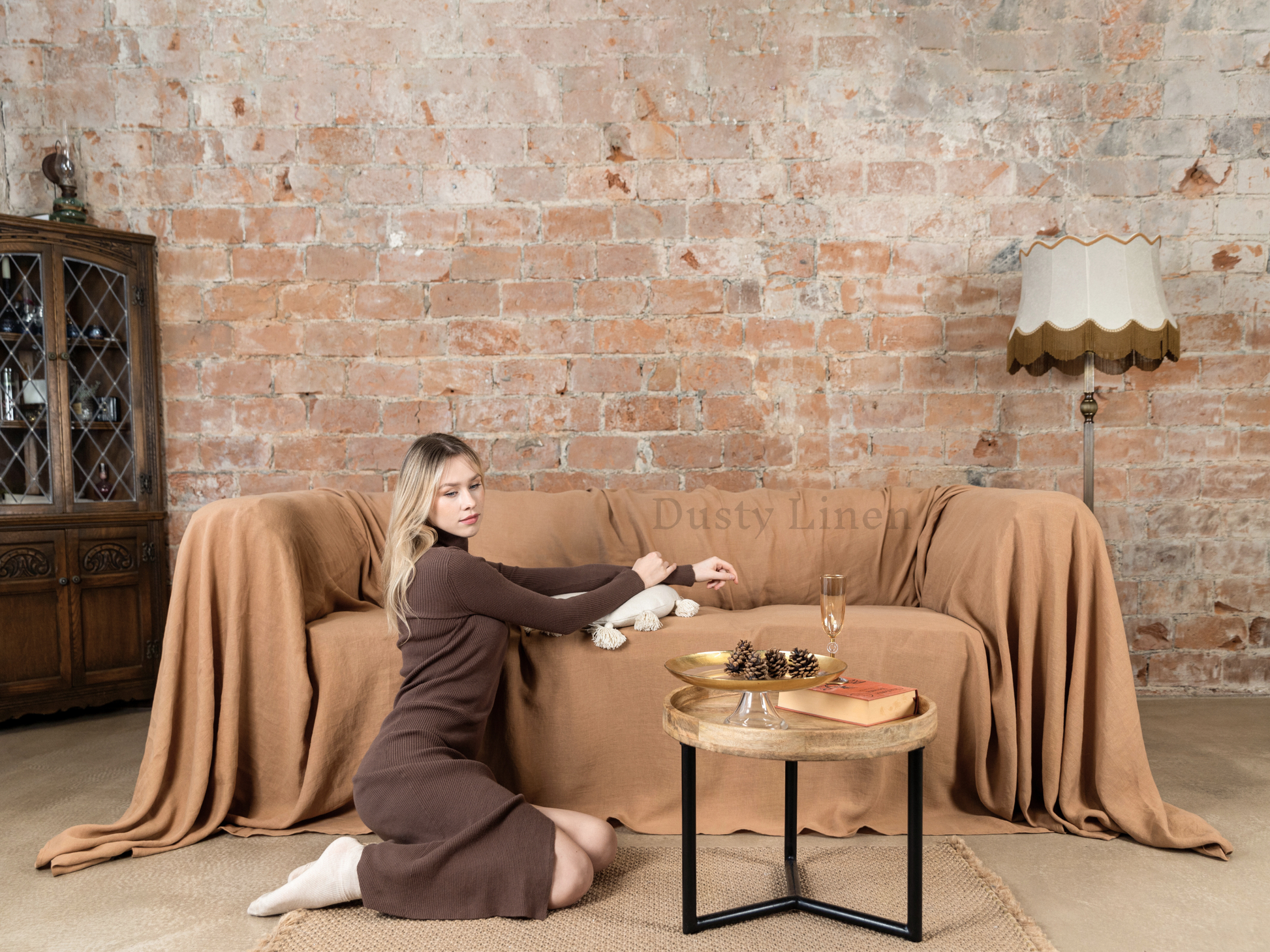 a woman sitting on a couch holding a teddy bear