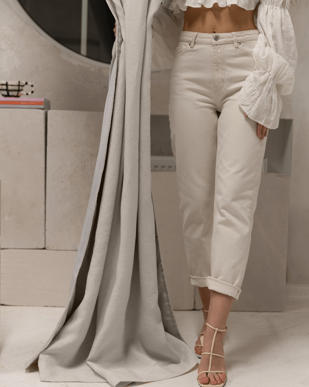 Woman beside cream linen blackout curtain panel, full length room view
