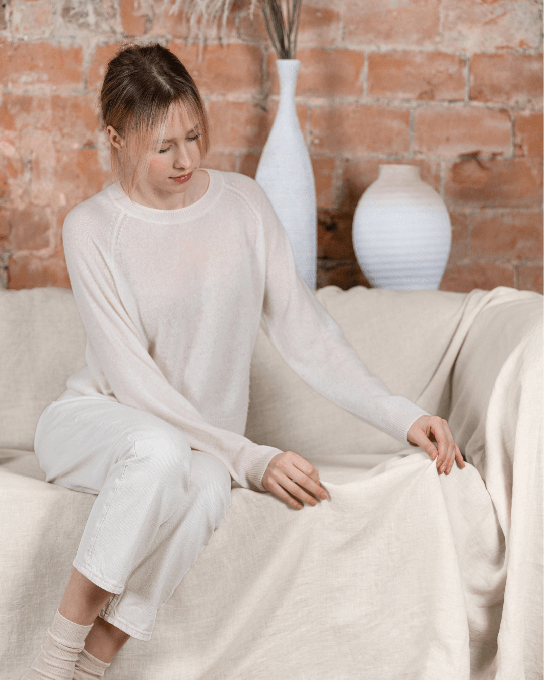 Woman on sofa with cream seamless linen couch cover, room lifestyle photo