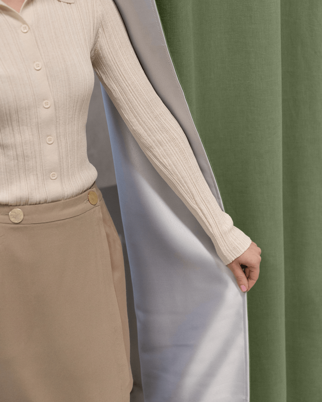 Woman beside khaki green linen blackout curtain panel, full length room view