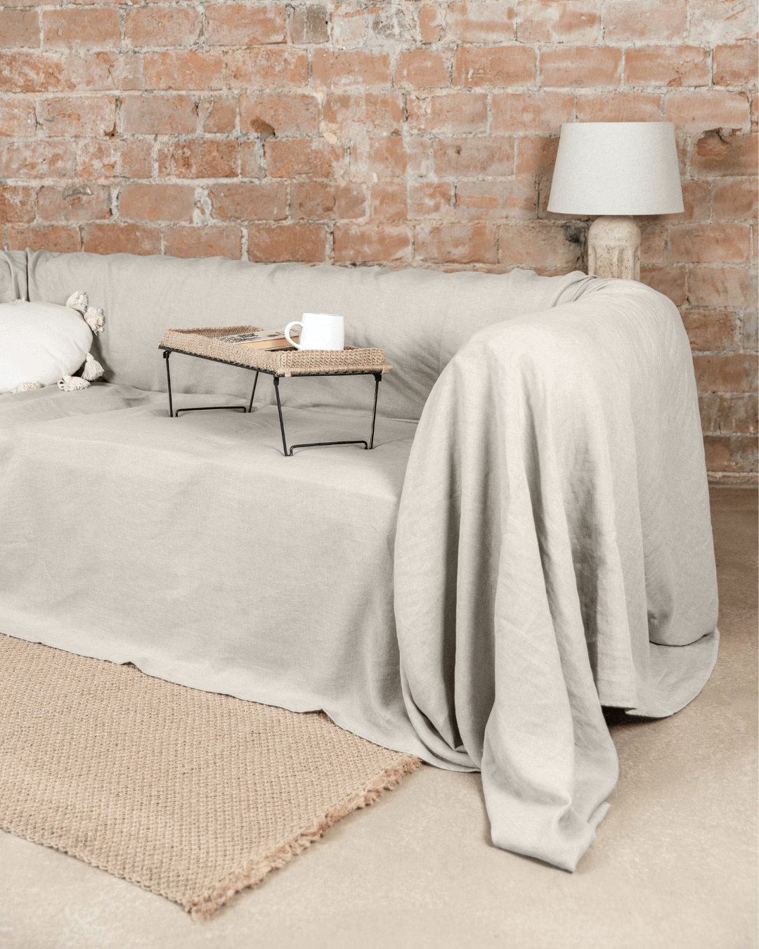 Natural linen sofa cover on couch in living room with coffee table