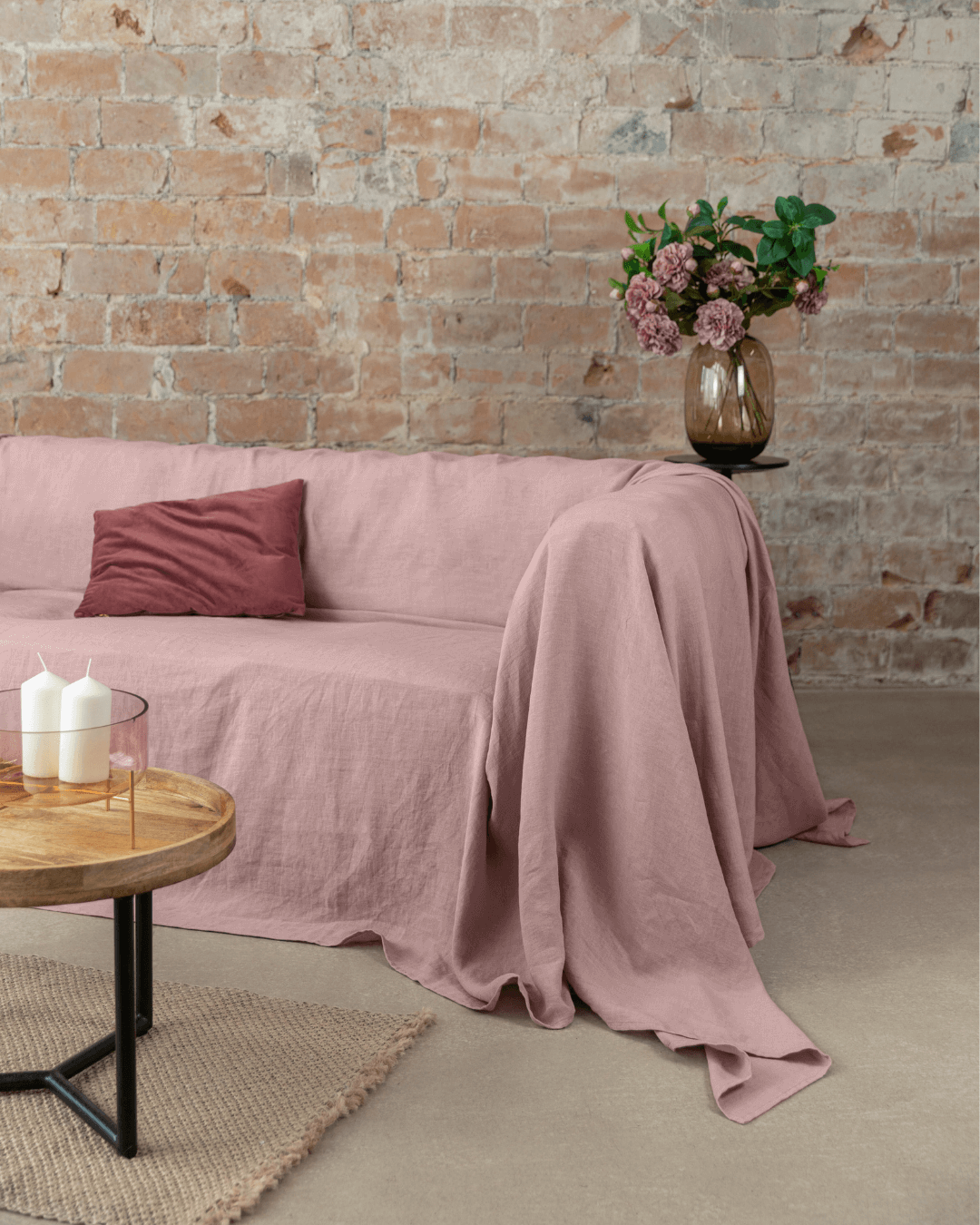 Dusty rose linen sofa cover draped on sofa in living room