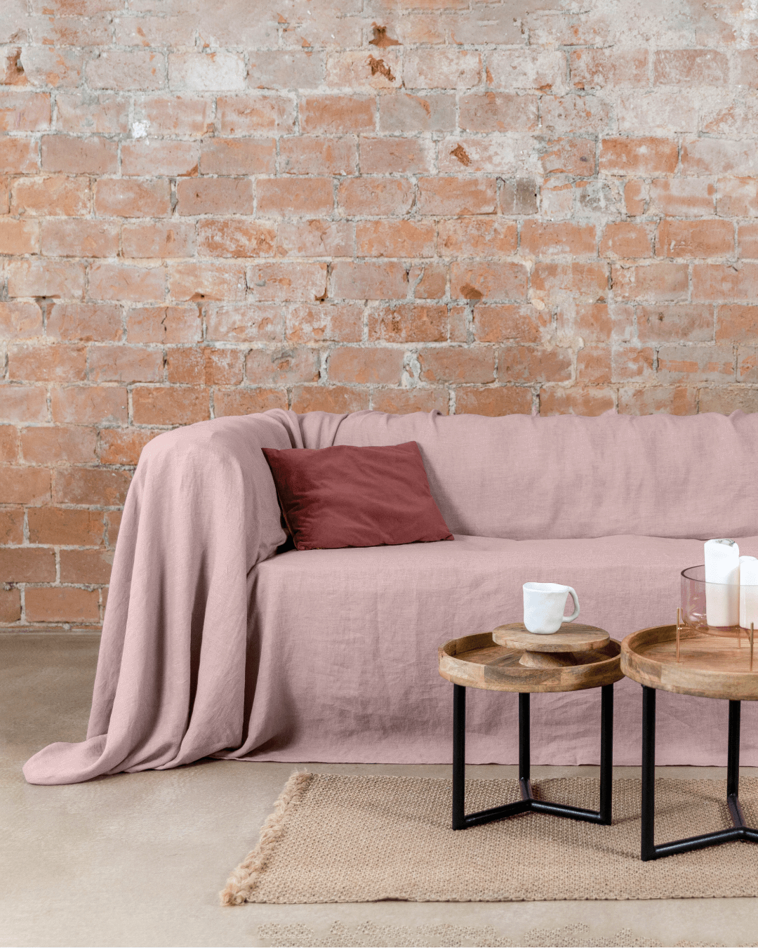 Dusty rose linen couch cover on sofa, full living room view with tables