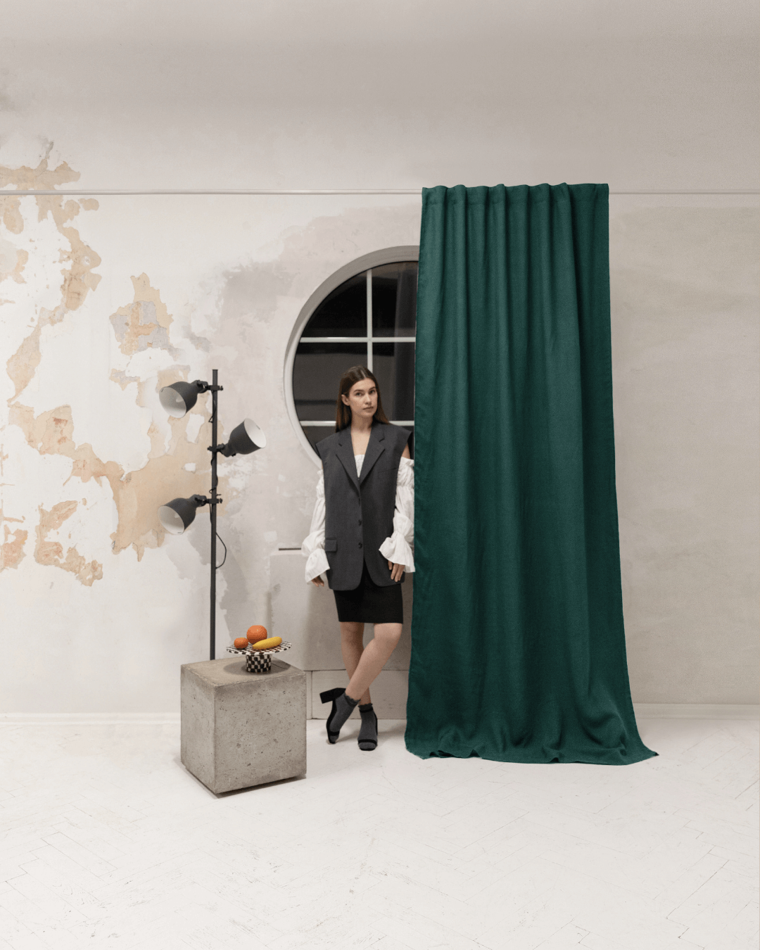Woman in front of emerald green linen blackout curtain panel