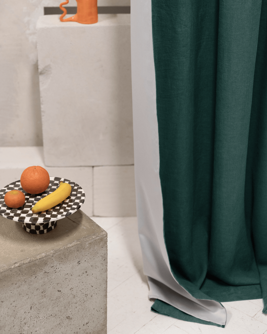 Emerald green linen blackout curtains with styled fruit bowl, interior detail