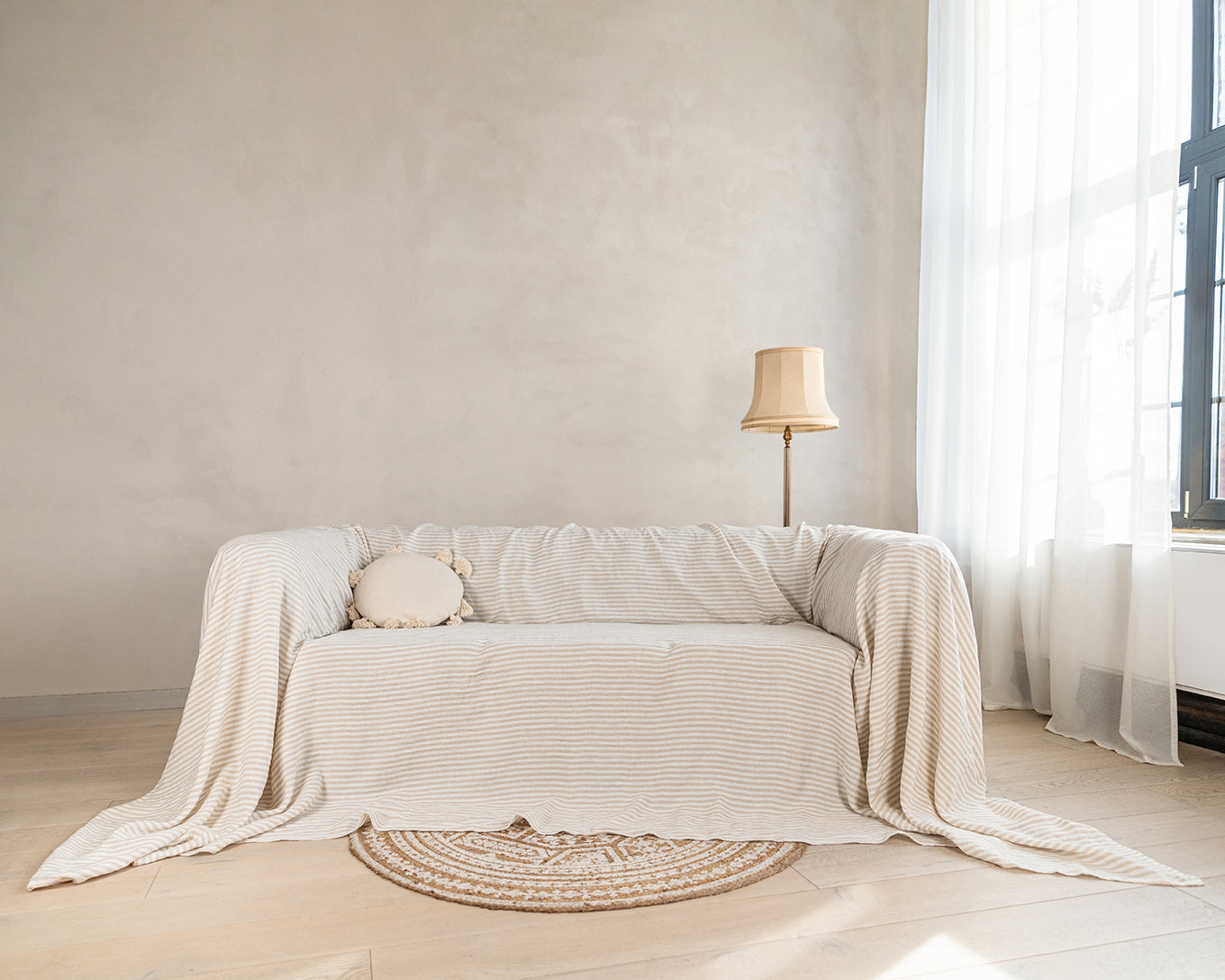 a living room with a couch covered in a blanket