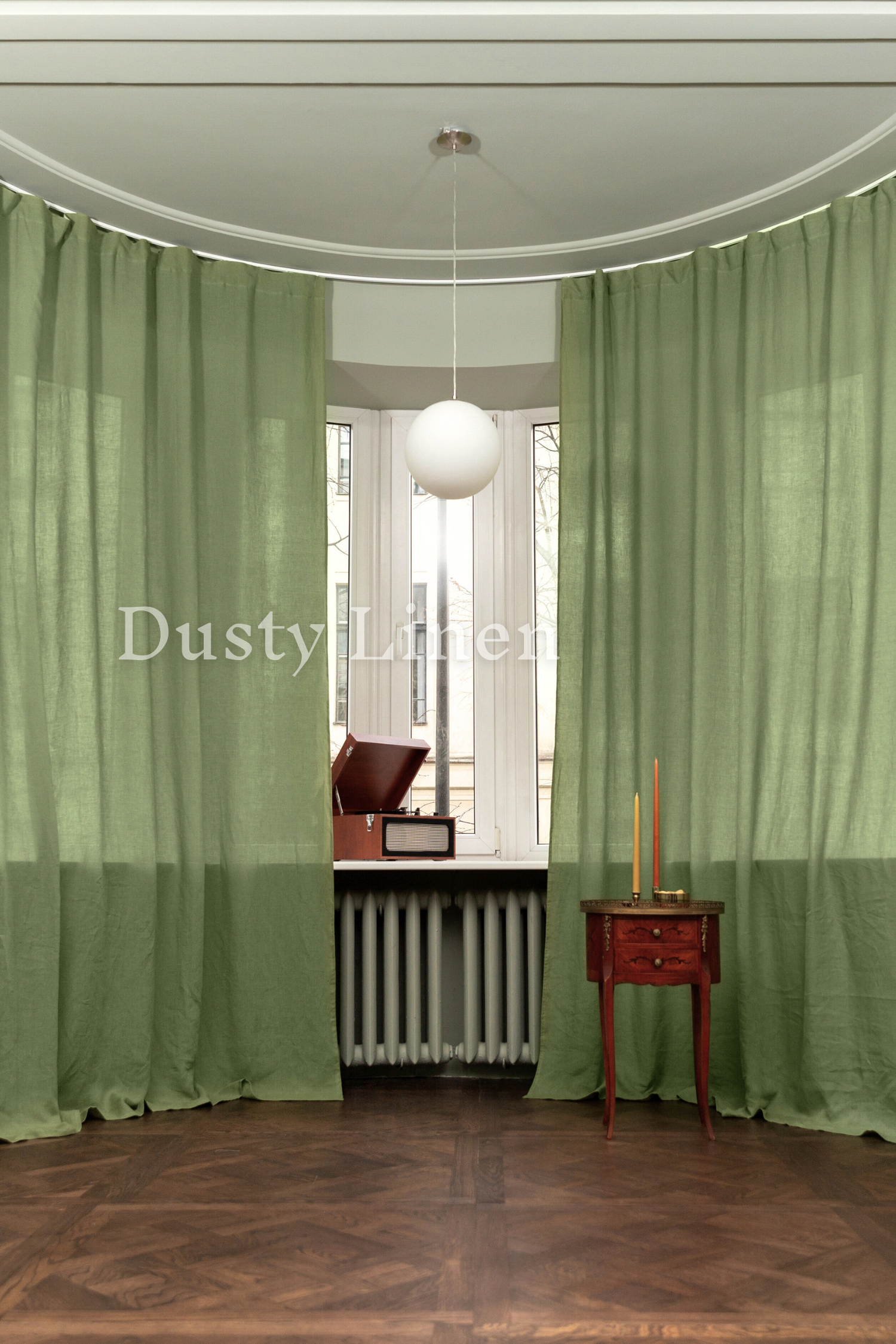 a living room with a radiator and green curtains