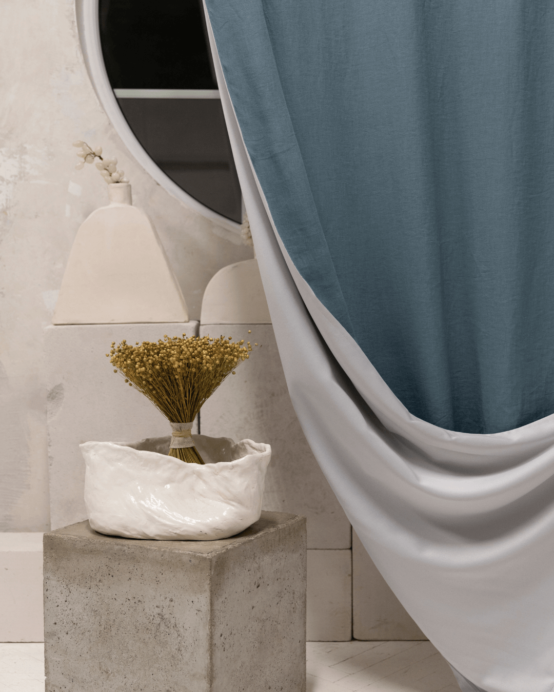 Gray blue linen blackout curtain with floral vase, styled interior