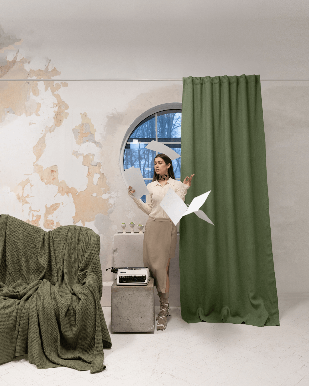 Woman beside khaki green linen blackout curtain at window