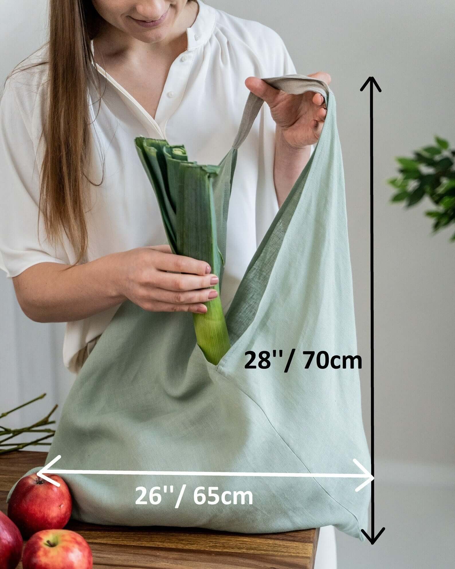 Large linen tote bag hanging, showing drape and natural texture