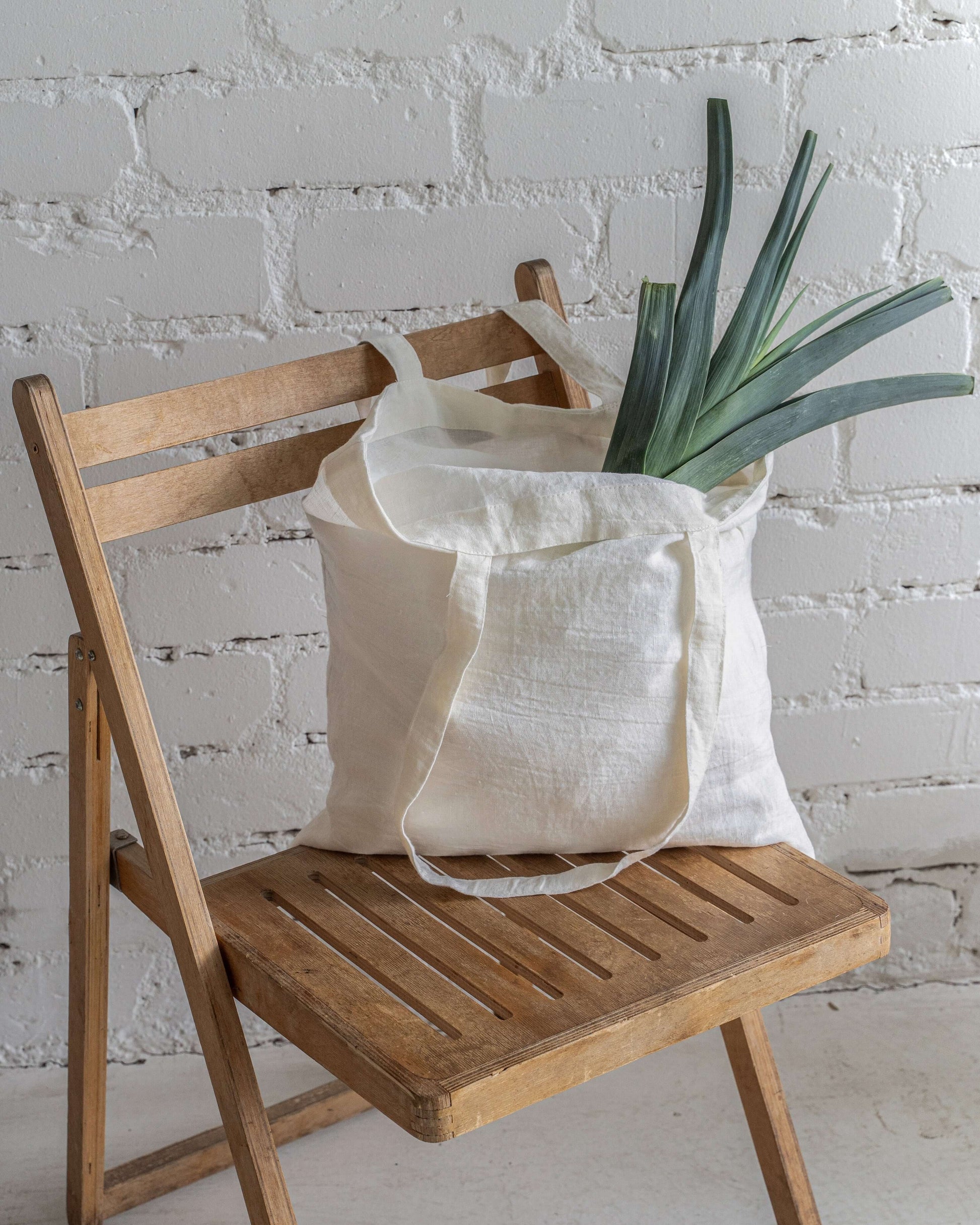 Linen tote bag in various colors laid flat, color range view