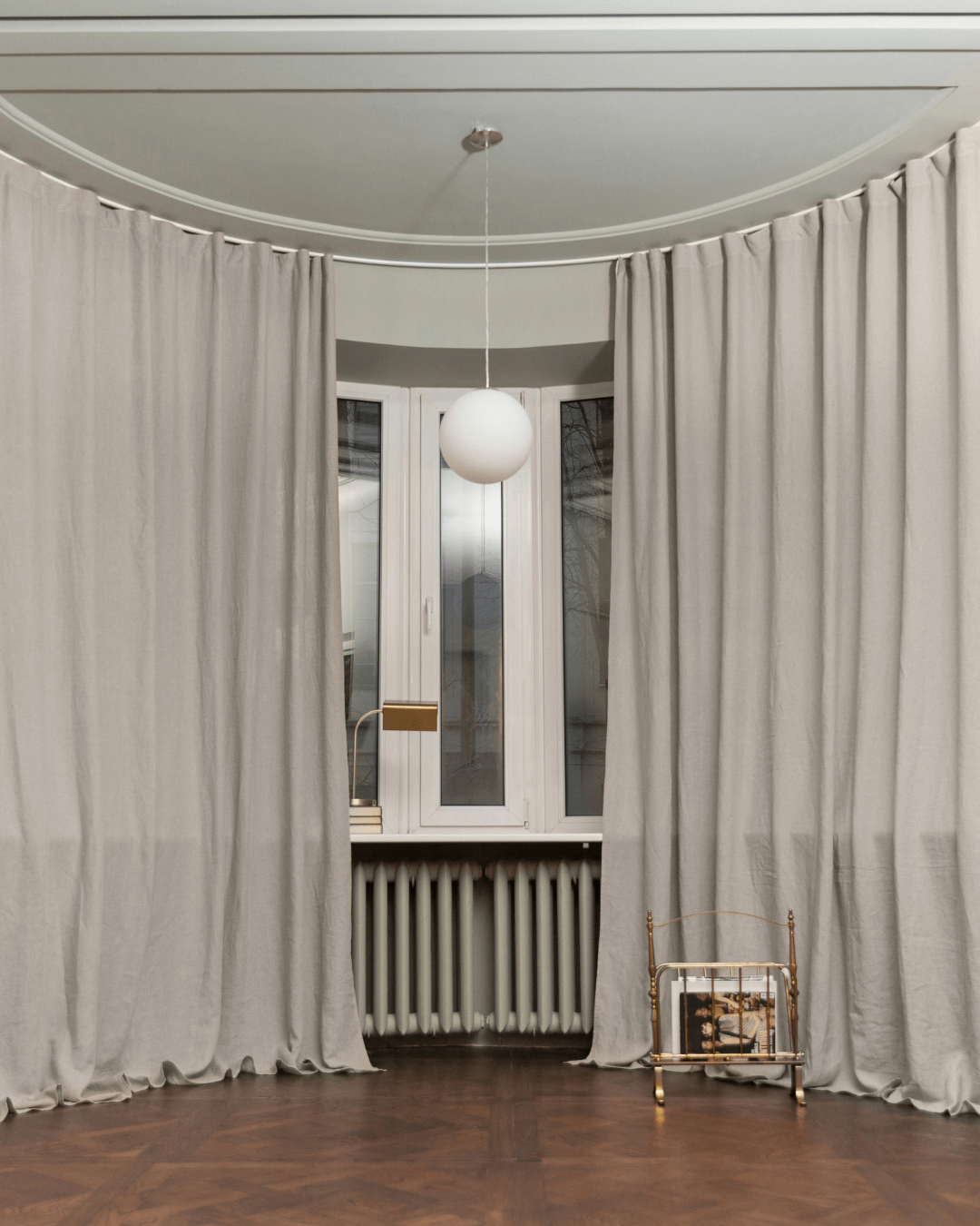 Natural linen curtains in living room with radiator and chair