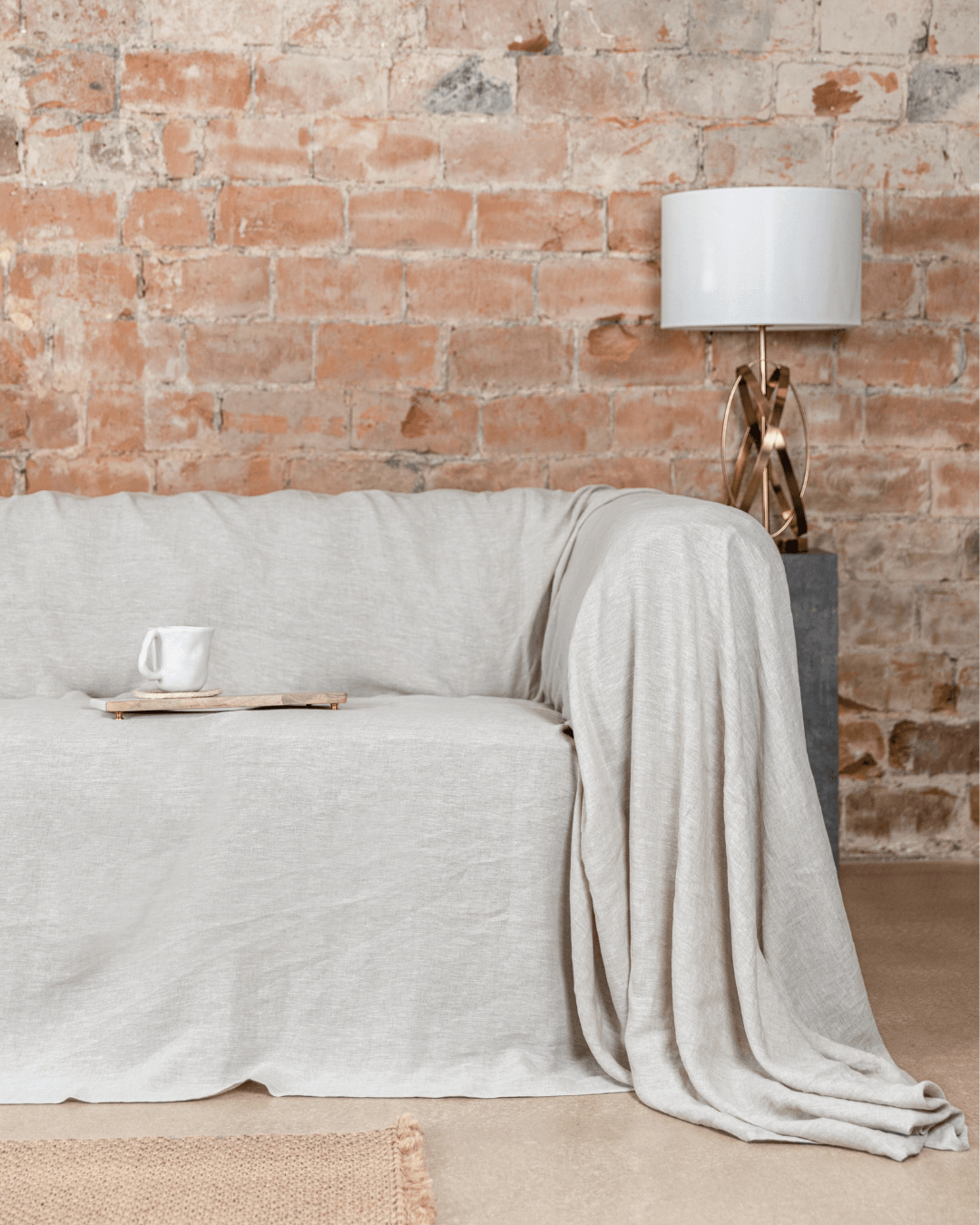 Seamless natural light linen couch cover on large sofa, front view