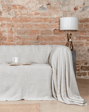 Seamless natural light linen couch cover on large sofa, front view