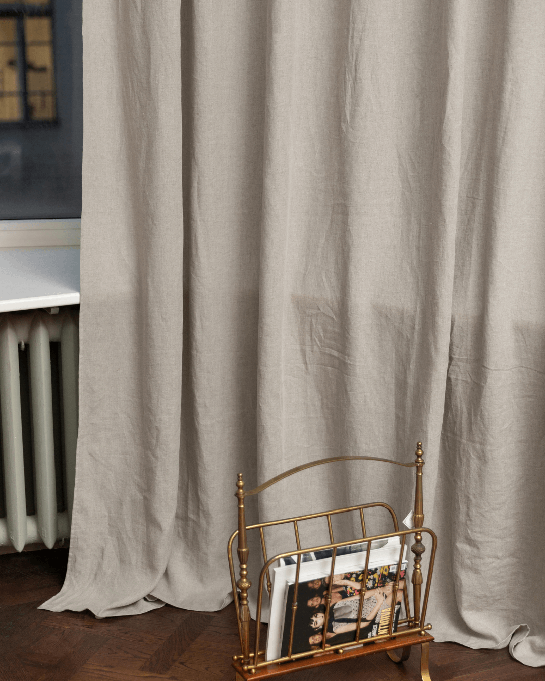 Woman on bed with natural linen curtains in background