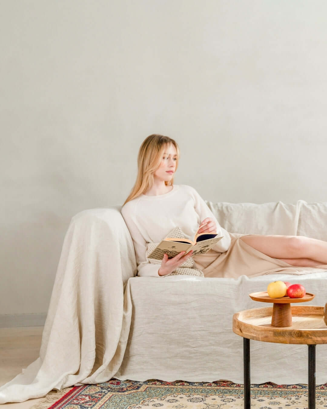 Woman on sofa with natural seamless linen couch cover, lifestyle photo