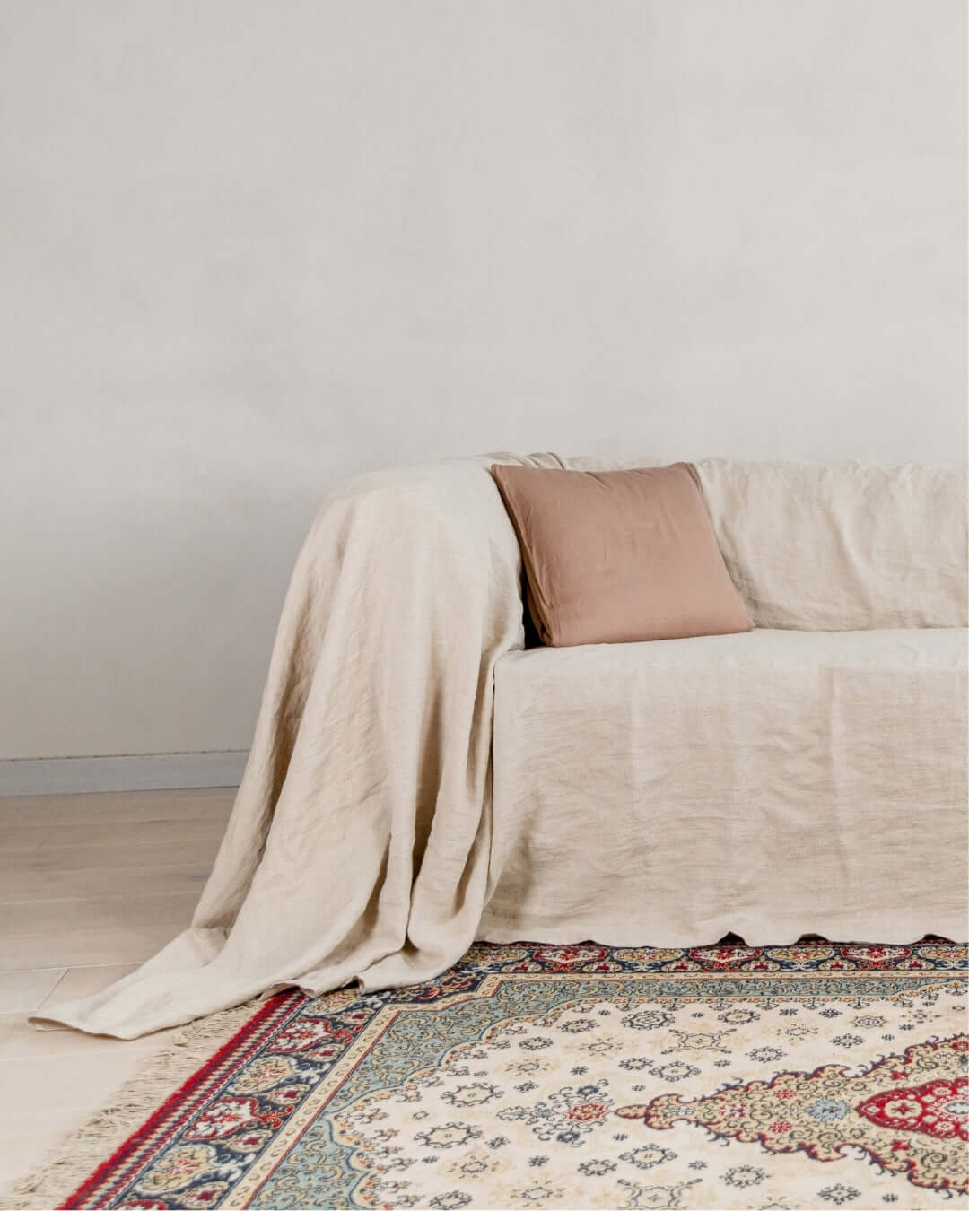 Natural linen couch cover loose drape on sofa, styled living room